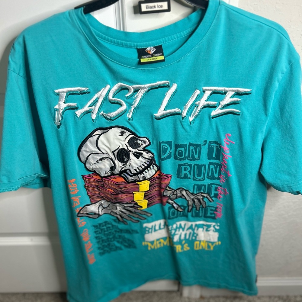 Teal Graphic Tee with Skull Design